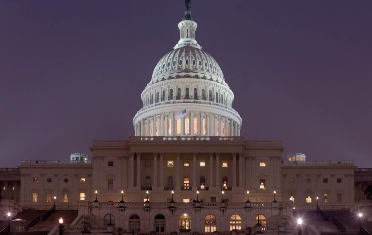 The United States Capitol lit up against a dark sky at night