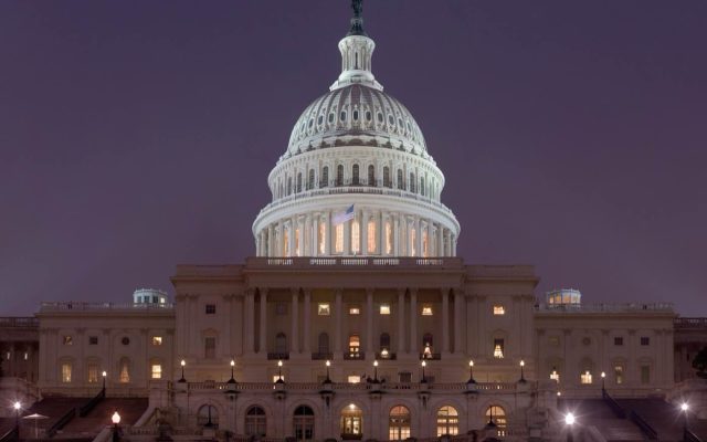 The United States Capitol lit up against a dark sky at night